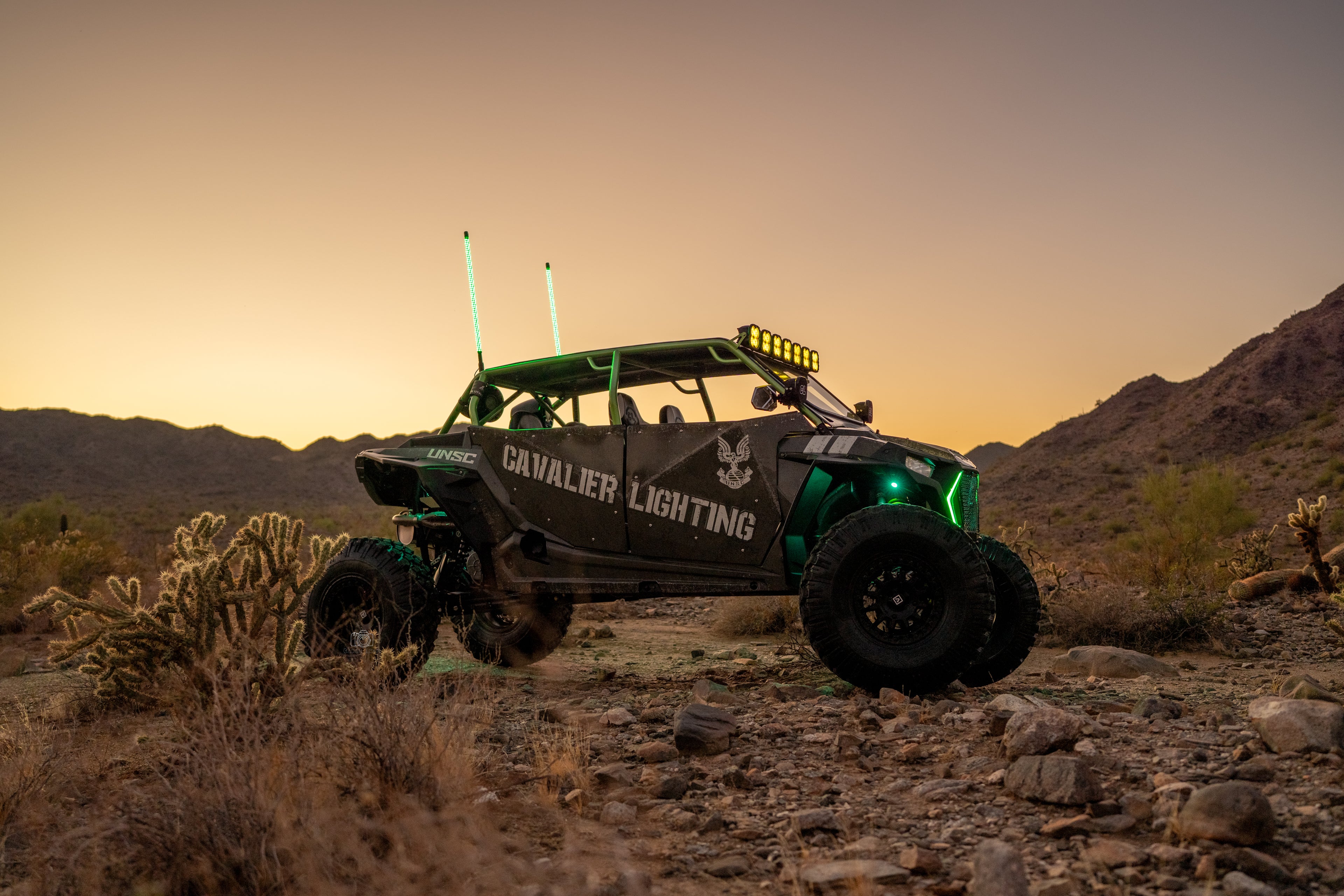 rzr xp1000 with custom cavalier lighting wrap and cavalier lighting modular bar installed on the roll cage. 5" pods on the a pillar. Valor wheels installed on the rzr xp