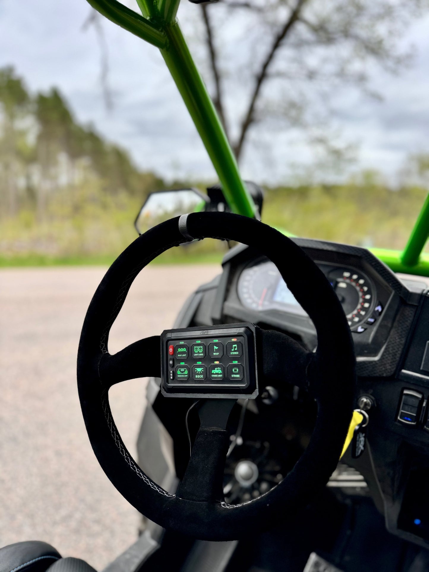 Cavalier Lighting 8 gang switch panel shown with optional 3d printed mount - mounted on a black ops machines steering wheel